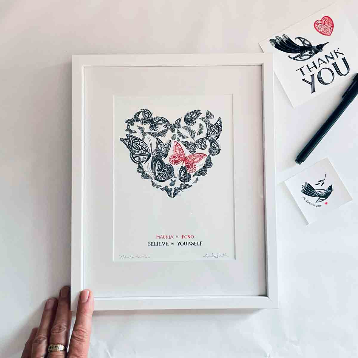 Mauria te Pono believe in yourself nz art print with maori art design butterflies in an aroha heart shape. With words in te reo maori and english. Nz wall art by Amber Smith.