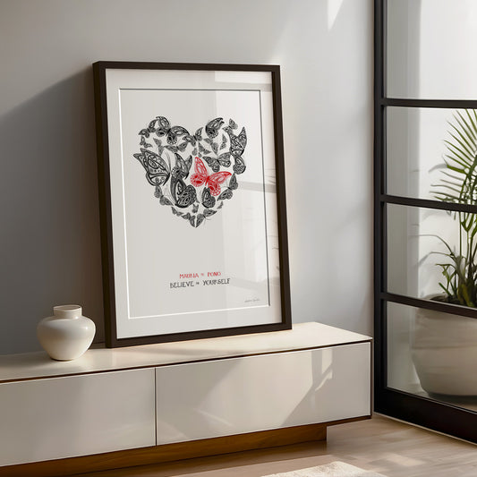 Framed New Zealand butterfly art print, Believe in Yourself – Mauria te Pono, featuring a heart-shaped arrangement of butterflies with a red butterfly at the centre and the message “Believe in Yourself” in English and te reo Māori, encouraging self-belief and courage for new beginnings.
