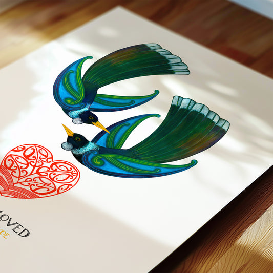 New Zealand tūī love art print, You Are Loved, featuring two blue and green tūī birds beside a red heart with a message of love in te reo Māori and English. Close up detail.