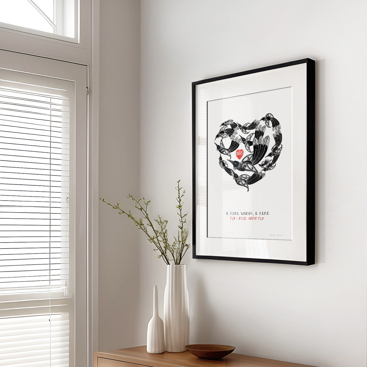 Framed New Zealand tūī art print, E Rere Wairua – Fly Free, Spirit Fly, featuring a gathering of tūī flying together in the shape of a heart, symbolising love, letting go and the enduring connection with someone who has passed away.