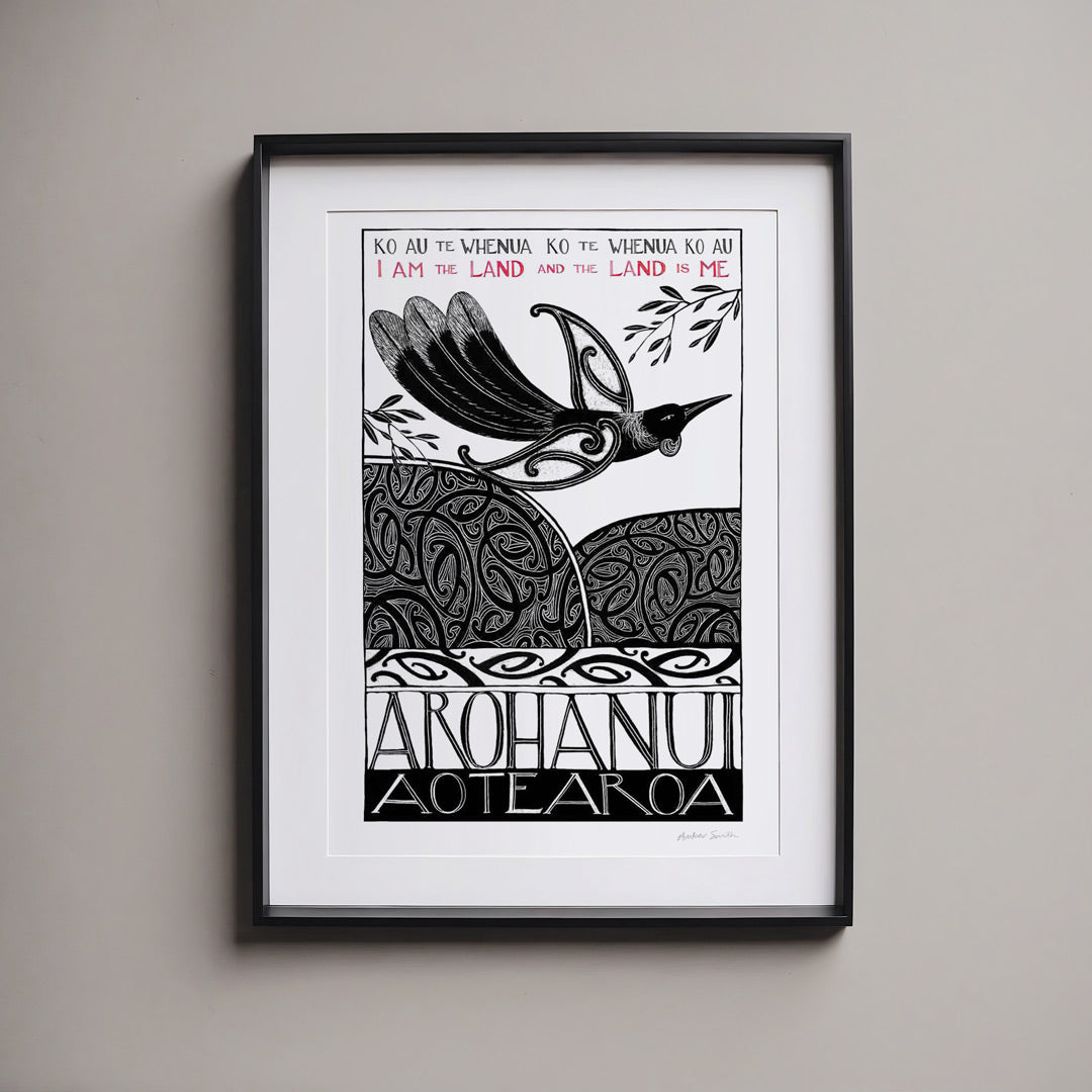 Framed New Zealand tūī art print, Ko au te Whenua – I Am the Land, featuring a tūī flying over the land and sea, with the te reo Māori whakataukī “Ko au te whenua, ko te whenua ko au” and its English translation, “I am the land and the land is me”.