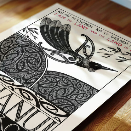 Detail of New Zealand tūī art print, Ko au te Whenua – I Am the Land, featuring a tūī flying over the land and sea, with the te reo Māori whakataukī “Ko au te whenua, ko te whenua ko au” and its English translation, “I am the land and the land is me”.