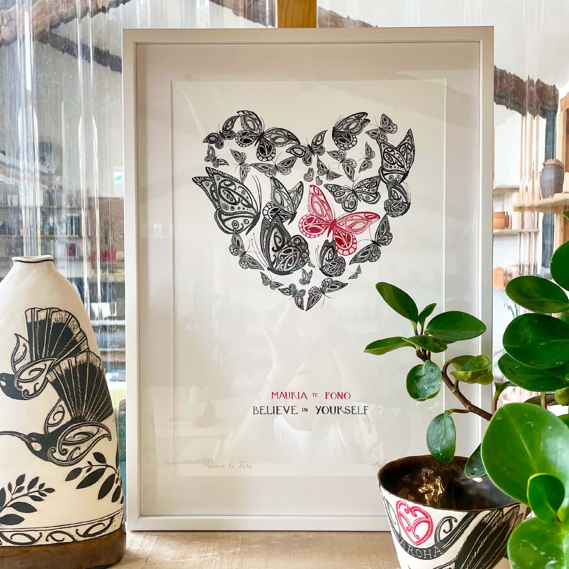 Mauria te Pono believe in yourself nz art print with maori art design butterflies in an aroha heart shape. With words in te reo maori and english. Nz wall art by Amber Smith.