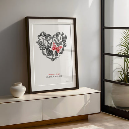 Framed New Zealand butterfly art print, Believe in Yourself – Mauria te Pono, featuring a heart-shaped arrangement of butterflies with a red butterfly at the centre and the message “Believe in Yourself” in English and te reo Māori, encouraging self-belief and courage for new beginnings.