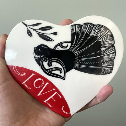 Ceramic wall heart with piwakawaka and the word Love